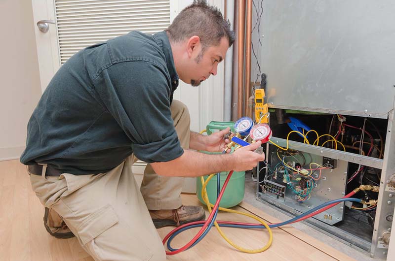 Technician working on the HVAC system