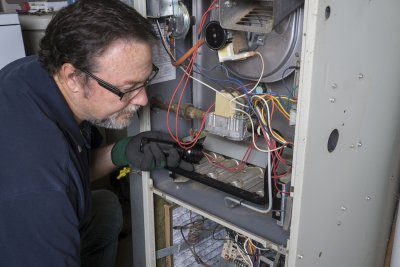 Technician repairing the heater at the home
