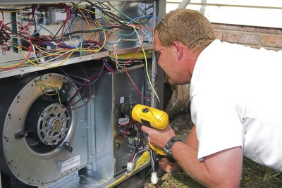 Technician checking HVAC unit