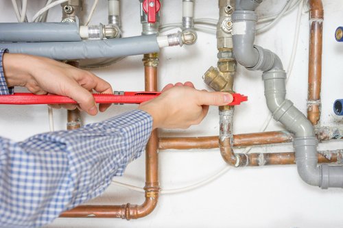 Technician fixing nuts of the pipe