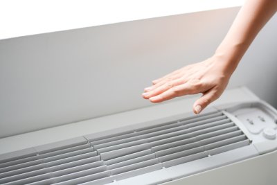 Hand in front of Air conditioner