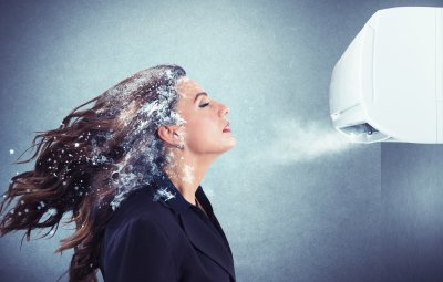 Lady with her hair frozen in front of air conditioner