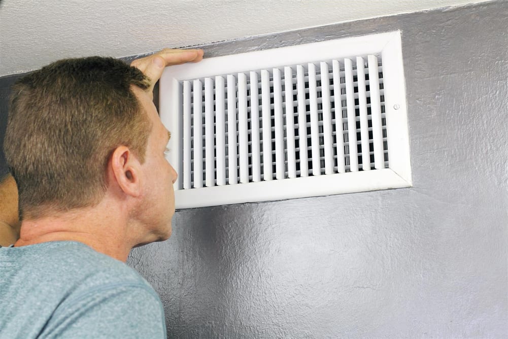 Man checking the home's air vents