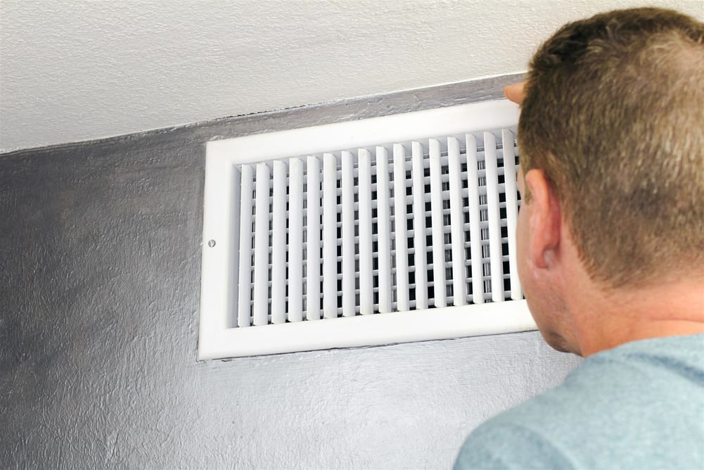 Man checking the home's air vents