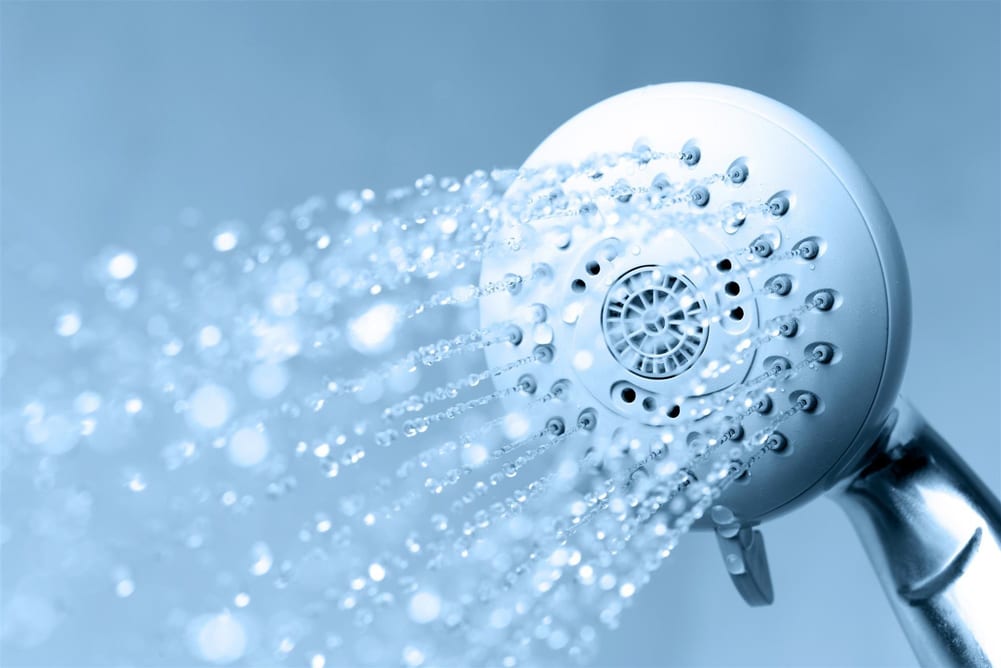 Water flow from shower with blue background