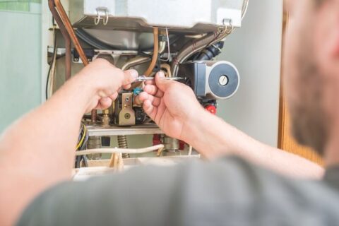 Technician finishing up a new furnace installation in an Annapolis, MD home