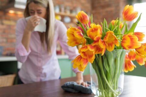 A woman sneezing due to bad air quality in Annapolis, MD home