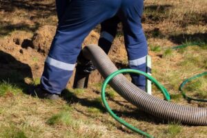 Man worker holding pipe, providing sewer cleaning service and unclogging mainline in Annapolis